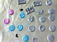 Partially painted clay pendants